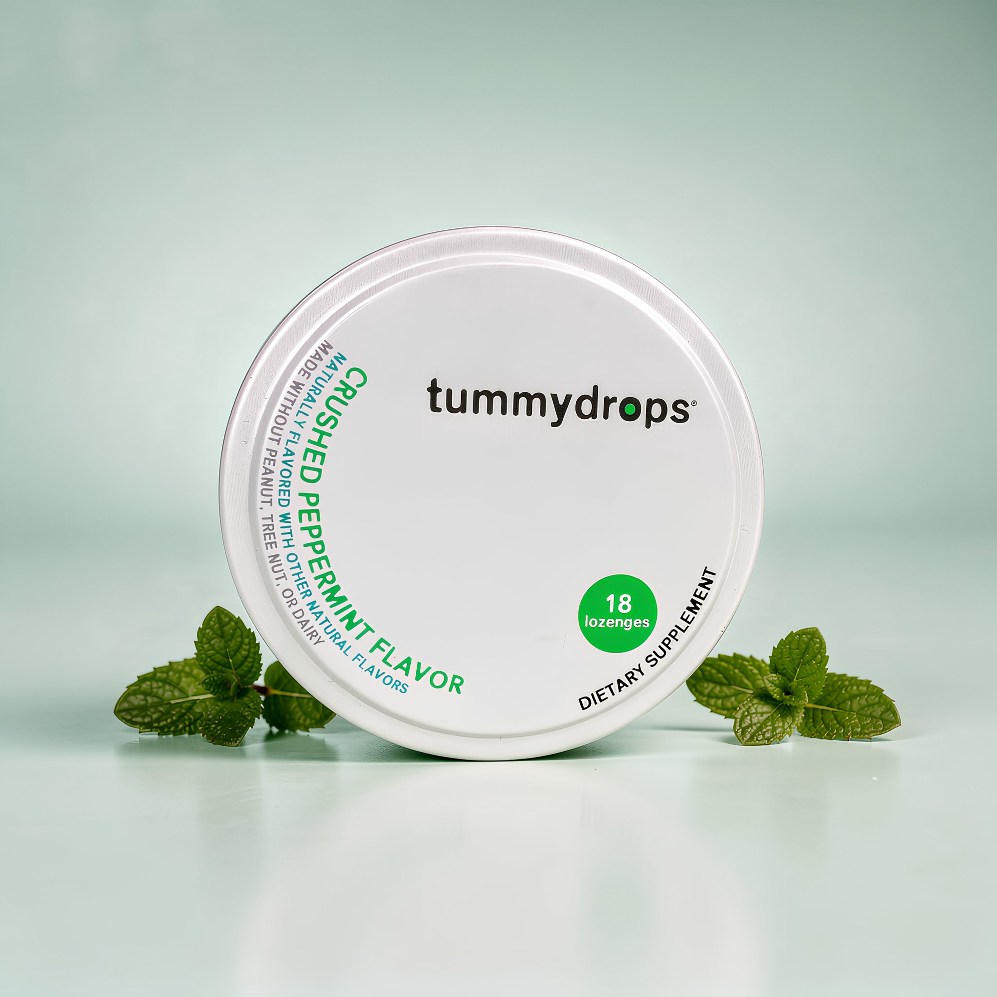 Tummydrops container with peppermint flavor on a light green background